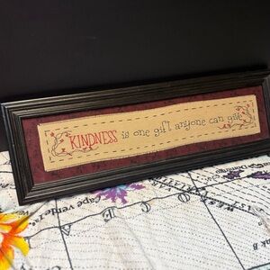 framed folk art featuring embroidered primitive lettering decorative border